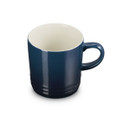 Navy blue stoneware mug with cream interior, angled top view.