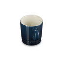 Navy blue stoneware mug with cream interior, angled rear view.