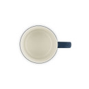Top-down view of navy blue stoneware mug showing cream interior.