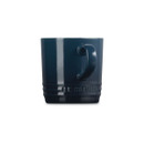 Navy blue stoneware mug with cream interior, rear view with handle.