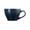 Navy blue stoneware mug with cream interior, side view.