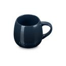 Navy blue stoneware coupe mug, angled top view.