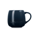 Navy blue stoneware coupe mug with handle, side view.