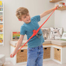 Child stretching a red Stretcherz Stretch Squad Mini figure wide across his body during playtime.