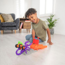 Young boy playing with Teamsterz Beast Machines Stinger Slam monster truck playset with purple scorpion and orange ramp.