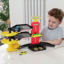 Young boy playing with Teamsterz Metro City Park and Drive Garage toy set with cars on ramps and working elevator.