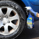 A view of a bottle of tyre shine bring sprayed on a tyre