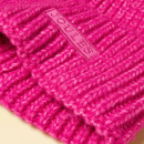 Close-up detail of the ribbed knit texture and Joules logo on a pink beanie hat.