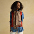 Woman wearing a Joules Langtree scarf in tan brown check pattern, styled over a denim shirt and rust knit vest.