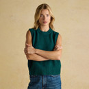 Woman wearing the Holly dark green sleeveless knit tank styled casually with jeans.