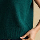 Detail shot of ribbed hem and soft knit texture of the Holly dark green tank.
