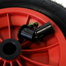 Close-up of the pneumatic wheel’s black valve fitting and red plastic hub.