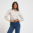 Women’s cream check shirt with long sleeves and button fastening, worn tucked into blue jeans.