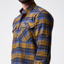 Close-up of a blue and mustard checked men’s shirt, highlighting the collar, button fastening and flap chest pockets.