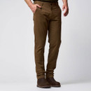 Man wearing slim-fit brown trousers with a dark green top and brown boots, shown from the front.