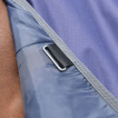 Detail of a metal D-ring and webbing loop at the edge of a navy turnout rug with grey binding.