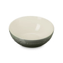A Thyme green Le Creuset bowl with a smooth cream interior, viewed from above at an angle highlighting the embossed holly detail.
