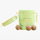Dubai Style Pistachio Truffles by Cartwright & Butler in a green gift tin, shown with chocolate truffles in front.