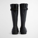 Rear view of Barbour black wellington boots featuring adjustable back straps and sturdy heel design.