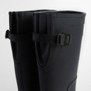 Top-down close-up of Barbour black wellington boots showing folded rim and buckle fastening.