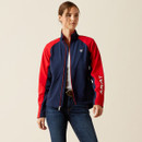 A person wearing a navy and red jacket with "Ariat" on the sleeve. They have jeans and a white shirt, exuding a sporty and casual vibe.