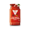 A jar of Cottage Delight Spiced Tomato & Caramelised Onion Chutney with a vibrant red label featuring tomatoes and green leaves.
