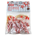 Package of mini peppermint candy canes with gold strings for hanging. Background features festive red and white holiday decorations.
