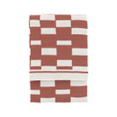 A folded nutmeg throw with a geometric block pattern.