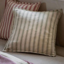 Sage green striped cushion on a sofa with a red striped cushion behind it.