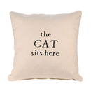 Cream cushion with embroidered paw prints and the phrase “the CAT sits here” stitched in black lettering on the front.