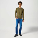 Model wearing Wrangler straight leg blue jeans in classic blue denim