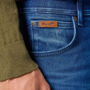 Close-up of Wrangler blue jeans front pocket with brown leather logo patch