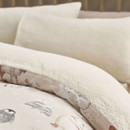 Detail view of the duvet cover folded back to reveal a fluffy sherpa lining, with polar bear and woodland animal illustrations visible on the outer fabric.