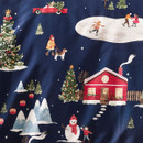 Detail of the Christmas bedding pattern featuring a red house with a decorated tree outside, a snowman, skaters on an ice rink, and a snowy woodland scene on a navy backdrop.