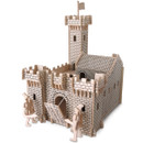 A detailed wooden toy castle featuring a drawbridge, battlements, and a tall tower with a flag. Two small toy figures stand guard, evoking a medieval theme.