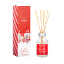 Winter Warmer reed diffuser with natural wooden reeds in a clear glass bottle, shown beside its festive red and white gift box decorated with snowy houses and trees.