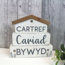 A view of a Welsh wooden decoration on a grey background