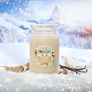 A white Yankee Candle labelled “Vanilla Flurries, placed in snow with vanilla pods, a flower, and tree bark beside it. A snowy mountain landscape glows in the background with softly falling snowflakes.