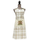 The plaid apron on the mannequin features a cow illustration with hearts and the text "Home is where the herd is," conveying a cosy, farmhouse feel.