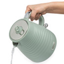 A hand pours water from a pastel green kettle with a ribbed texture and chrome handle. The design is sleek and modern, conveying functionality.
