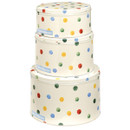 Stacked set of Emma Bridgewater polka dot cake tins in three sizes, featuring colourful red, blue, green, and yellow spots on a cream background.