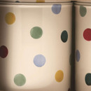 Close-up of Emma Bridgewater Polka Dot caddy design showing vibrant red, green, yellow, and blue spots on cream tin surface.
