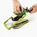Hand slicing aubergine with Joseph Joseph multi-grip mandoline adjustable slicer, creating even slices.