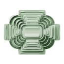 Overhead view of pastel green food container lids neatly stacked together.