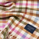 Detailed texture shot of soft woven scarf showing pink, green, and tan checks with stitched Joules label.
