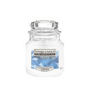 A glass jar of Yankee Candle's "Home Inspiration" in the "Soft Cotton" scent. The label features soft blue fabric. The candle is white, suggesting freshness.