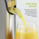 A juicer with an anti-drip spout pours yellow juice into a glass, preventing spills. Text reads: "Anti-drip sprout. No more mess." Clean and efficient vibe.