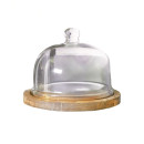 A round glass cake dome with wooden base.