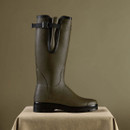 Side profile of a Le Chameau tall green wellington boot with adjustable calf strap and rugged black outsole.