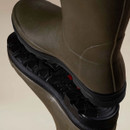 Close-up of Le Chameau wellington boots showing the textured rubber uppers and deep-tread black soles.